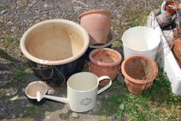 A quantity of glazed and Terracotta plant pots plus small watering can