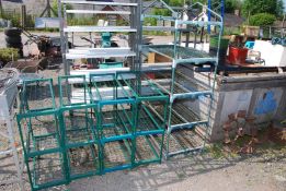A small greenhouse frame and four shelf units.
