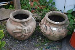 Two planters with sun and moon detail.