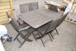 A teak table and six chairs (one chair a/f), 55'' x 36''.