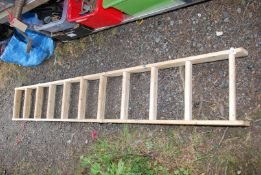 A wooden fold up three stage loft ladder, eleven rungs.