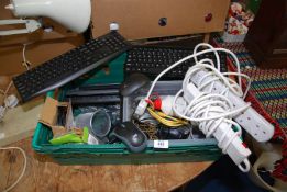 A basket containing keyboards, computer mouse, extension leads, multi sockets etc.