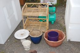 A bamboo shelf unit, small bird bath two glazed pots and one other.