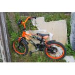 A Strike 16 child's orange bike.