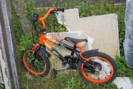 A Strike 16 child's orange bike.