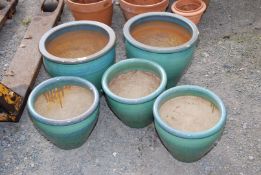Five glazed plant pots, one with a chip.