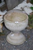 A small concrete urn, 12 1/2'' diameter x 13 1/2'' high.