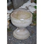 A small concrete urn, 12 1/2'' diameter x 13 1/2'' high.