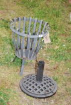 A metal brazier and parasol stand.