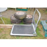 A trolley on castors, with fold down handle, 35'' x 23 1/2''.