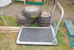 A trolley on castors, with fold down handle, 35'' x 23 1/2''.