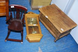 A dolls rocking chair, wall clock and small oak chest.
