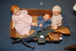 A box of jointed dolls and a plastic gun.