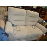 An electrically operated double reclining Antler beige upholstered contemporary two seater settee.