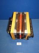 A small Accordion in original box and supplied by J.W. & E. Austin, 4 Mealcheapen St., Worcester.