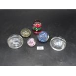 Six paperweights including plain clear glass, mauve swirl, pink flower etc.