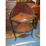 A Georgian Mahogany bow fronted corner Washstand with a lower shelf with a drawer having a drop