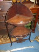 A Georgian Mahogany bow fronted corner Washstand with a lower shelf with a drawer having a drop
