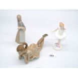 A Lladro Lady carrying a pig,