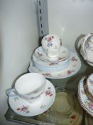 A small quantity of Shelley teaware in floral with blue rims plus an odd Shelley saucer.