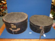 Two large black hat boxes, both lined, some wear.