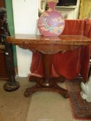 A 19th century Regency design Mahogany flap over card table standing on a tapering octagonal pillar