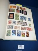 A Stamp album containing a large quantity of British Commonwealth stamps from Queen Victoria to