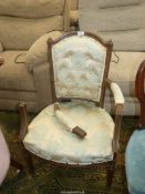An elegant oak framed open armed Elbow Chair standing on turned and fluted legs, the seat,