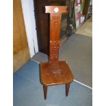 A mixed hardwoods spinning chair having a carved fleur de lys to the solid seat, 39" high,