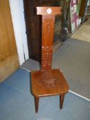 A mixed hardwoods spinning chair having a carved fleur de lys to the solid seat, 39" high,