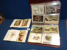 A small album of old postcards and large album of early 20th century greetings cards etc.