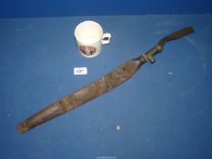 A 'Sykes' brass and leather shot flask belt, leather a/f., and a china 'Peace 1919' mug.