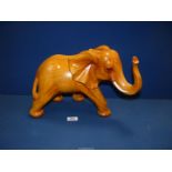 A large golden tone carved figure of an Elephant, 19'' x 11 1/2''.