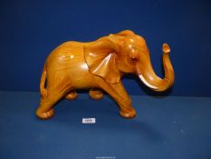 A large golden tone carved figure of an Elephant, 19'' x 11 1/2''.