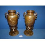 A pair of oriental Bronze Vases standing on a circular base and three serpentine feet, 13" high.