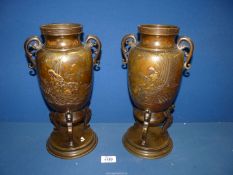 A pair of oriental Bronze Vases standing on a circular base and three serpentine feet, 13" high.