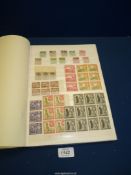 A stock book containing a large quantity of British stamps of the Commonwealth including Queen