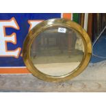 A circular brass framed wall mirror, 14 1/2'' diameter.