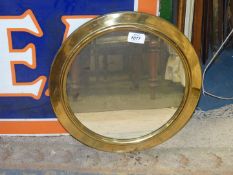 A circular brass framed wall mirror, 14 1/2'' diameter.