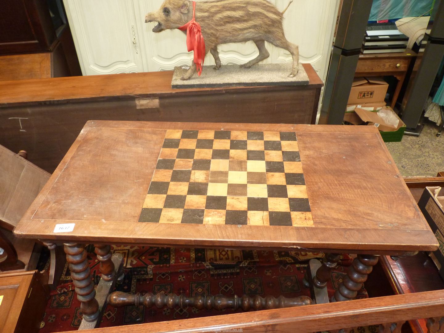 A Victorian mixed woods centre Table standing on turned legs united by a central stretcher and