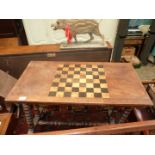 A Victorian mixed woods centre Table standing on turned legs united by a central stretcher and