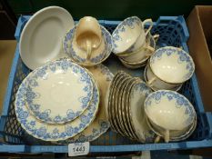 A Chelson china part tea set in blue with swags on white ground.