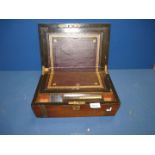 A Mahogany Writing slope with brass shield to lid and black tooled leather insert,