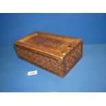 An oak Spice (?) Box with geometric carved detail, sliding lid and six interior compartments,