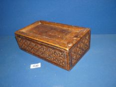 An oak Spice (?) Box with geometric carved detail, sliding lid and six interior compartments,