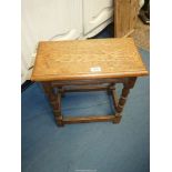 An Oak Joynt Stool standing on turned legs with perimeter stretchers, the top having a moulded edge,