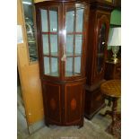 A Mahogany bow fronted display Cabinet on Cupboard with "H'' hinges and opposing inlaid detailed