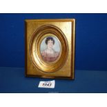 A gilt framed miniature oil/mixed media of a lady in a rose colour dress with delicate lace collar,