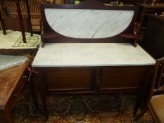 An Edwardian Mahogany Marble top Washstand and having an upstand with veined marble inset and with