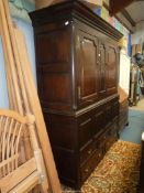 A most substantial peg joined dark Oak cupboard on chest having a pair of opposing doors with